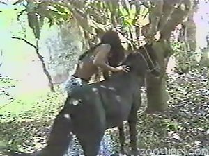 Naughty black woman having sex outdoors with a pony